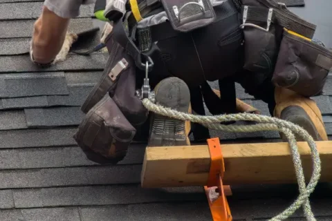 A person installing a shingle roof in the Denver metro area